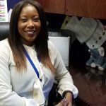 Our school Principal, Ms. Jovan Moore. She is currently sitting in here office inside of the Main office!