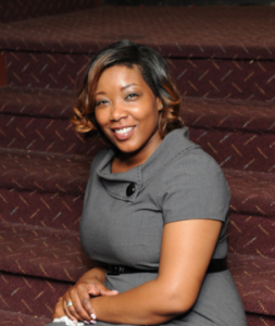 Our school Principle, Ms. Jovan Moore. Sitting on a flight of stairs.