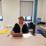 Ms. Jones, our school nurse, sitting at her desk.