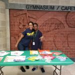 Ms. Ericka Andrews and Justin Robinson, a student, at Back to School Night passing out flyers for health and nutrition!